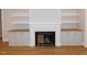 Modern fireplace with built-in cabinetry and wood mantel at 81 Autumn Gate St, Pittsboro, NC 27312