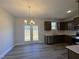 Dining area with chandelier and French doors leading to deck at 97 Mapledale Ct, Benson, NC 27504