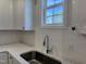 Modern kitchen with white cabinets and a stainless steel sink at 99 Mapledale Ct, Benson, NC 27504