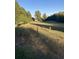 Long grass yard with trees and a distant house at 878 Green Hill Rd, Franklinton, NC 27525