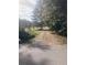 Long driveway leading to a home, surrounded by lush trees and greenery at 878 Green Hill Rd, Franklinton, NC 27525