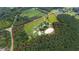 Aerial view of property showing home, barns, and riding arena at 8401 Mitchell Mill Rd, Zebulon, NC 27597