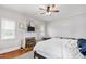Cozy bedroom featuring a fireplace, hardwood floors, and a comfortable bed at 8401 Mitchell Mill Rd, Zebulon, NC 27597