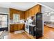 Kitchen boasts wood cabinets, white appliances, and an open view to the living room at 8401 Mitchell Mill Rd, Zebulon, NC 27597
