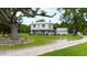 Farmhouse with wraparound porch, large tree, and stone accents at 8401 Mitchell Mill Rd, Zebulon, NC 27597