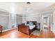 Charming bedroom with hardwood floors and a large sleigh bed at 8401 Mitchell Mill Rd, Zebulon, NC 27597