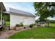 White storage shed with a metal roof and flower boxes at 8401 Mitchell Mill Rd, Zebulon, NC 27597