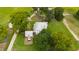 Aerial view of a farmhouse with surrounding land and outbuildings at 8401 Mitchell Mill Rd, Zebulon, NC 27597