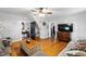 Spacious living room with hardwood floors, sectional sofa, and ceiling fan at 8401 Mitchell Mill Rd, Zebulon, NC 27597