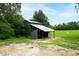Green storage shed with metal roof, providing ample storage at 8401 Mitchell Mill Rd, Zebulon, NC 27597