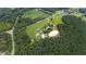 Aerial view of property with home, barns, and riding arena at 8401 Mitchell Mill Rd, Zebulon, NC 27597