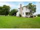 Farmhouse exterior view showcasing lawn and landscaping at 8401 Mitchell Mill Rd, Zebulon, NC 27597