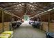 Spacious barn with multiple stalls, hay storage, and tack area at 8401 Mitchell Mill Rd, Zebulon, NC 27597