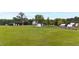 Aerial view showing farmhouse, barns, and expansive pastures at 8401 Mitchell Mill Rd, Zebulon, NC 27597