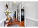Long hallway with hardwood floors and dark doors at 8401 Mitchell Mill Rd, Zebulon, NC 27597