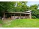 Rustic run-in shed with several horse stalls and adjacent woods at 8401 Mitchell Mill Rd, Zebulon, NC 27597