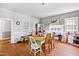 Quaint dining area with a light green table and chairs, hardwood floors, and natural light at 8401 Mitchell Mill Rd, Zebulon, NC 27597