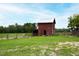 Red barn with metal roof and large double doors at 8401 Mitchell Mill Rd, Zebulon, NC 27597