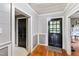 Hallway with hardwood floors and black doors at 8401 Mitchell Mill Rd, Zebulon, NC 27597