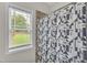 Shower with geometric patterned curtain and window at 97 Shady Oaks Dr, Benson, NC 27504