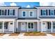 Three-unit townhome building with gray siding and black shutters at 98 Linda St, Princeton, NC 27569
