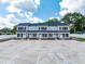 Three-unit building with gray siding, black shutters, and ample parking at 98 Linda St, Princeton, NC 27569