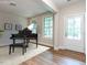 Bright living room with hardwood floors and a grand piano at 121 Inwood Forest Dr, Raleigh, NC 27603