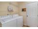 Bright laundry room features washer, dryer, and ample shelving at 140 Applegate Dr, Franklinton, NC 27525