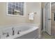 Bathroom with a garden tub, shower, and neutral tile floors at 140 Applegate Dr, Franklinton, NC 27525