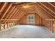 Unfinished attic space with window and wood framing at 140 Applegate Dr, Franklinton, NC 27525