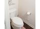 Small bathroom with white toilet and fixtures, and a decorative wall accent at 509 Hallie Long Ln, Burlington, NC 27217