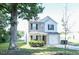 Two-story house with beige and white siding, a two-car garage, and landscaping at 509 Hallie Long Ln, Burlington, NC 27217