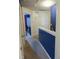 Upstairs hallway with blue accent wall and geometric wallpaper at 509 Hallie Long Ln, Burlington, NC 27217