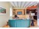 Open living room with built-in entertainment center and teal sofa at 103 W Main St # 405, Durham, NC 27701