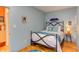 Cozy bedroom with wrought iron bed frame and light blue walls at 103 W Main St # 405, Durham, NC 27701