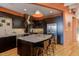 Modern kitchen with dark cabinets, stainless steel appliances, and an island at 103 W Main St # 405, Durham, NC 27701