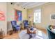 Bright living room with hardwood floors, comfortable seating, and large windows at 103 W Main St # 405, Durham, NC 27701