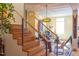 Modern staircase with wood steps and metal railings, leading to upper level at 103 W Main St # 405, Durham, NC 27701