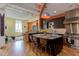 Open concept kitchen with island, breakfast bar, and hardwood floors at 103 W Main St # 405, Durham, NC 27701