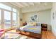 Spacious main bedroom with hardwood floors and access to a balcony at 103 W Main St # 405, Durham, NC 27701