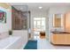 Spa-like bathroom with soaking tub, walk-in shower, and modern vanity at 103 W Main St # 405, Durham, NC 27701