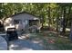 Rustic cabin nestled in wooded lot with ATV at 1612 Us 64, Apex, NC 27523