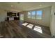 Spacious living room with hardwood floors and sliding glass doors to backyard at 140 Chestnut Oak Ln, Lillington, NC 27546