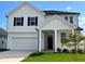 Two-story white house with black shutters and porch at 140 Chestnut Oak Ln, Lillington, NC 27546