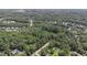 Aerial view of a lot nestled in a wooded area near homes at 9500 Ligon Mill Rd, Wake Forest, NC 27587