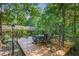 Wooden deck with seating area surrounded by trees at 9500 Ligon Mill Rd, Wake Forest, NC 27587