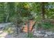 Wooden stairs lead to a deck nestled in a lush, wooded backyard setting at 9500 Ligon Mill Rd, Wake Forest, NC 27587