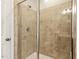 Shower with glass enclosure and beige tile at 622 Chronicle Dr, Cary, NC 27513
