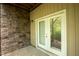 French doors leading to a patio with stone accents at 622 Chronicle Dr, Cary, NC 27513