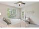 Bright bedroom with a queen bed, window with blinds, and door to balcony at 622 Chronicle Dr, Cary, NC 27513